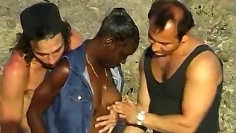 Two White Men Pleasure A Black Woman On The Beach