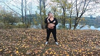 Middle-Aged Woman With Curves Indulges In Breast Play Outdoors In A Park By The Lake